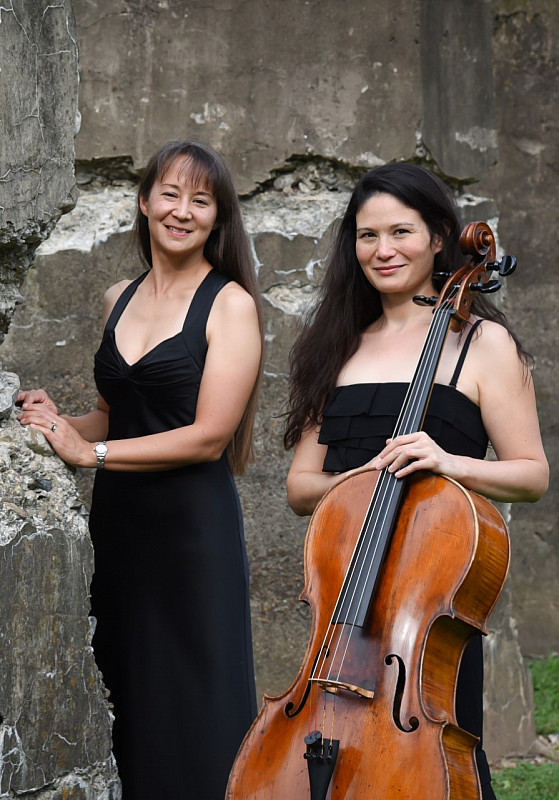 Bardin and Niskala standing outdoors with cello