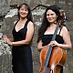 Bardin and Niskala standing outdoors with cello