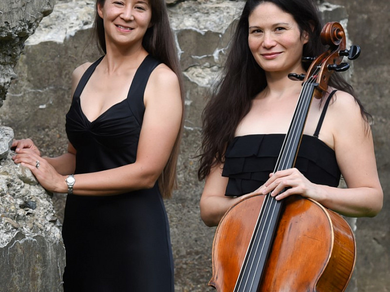 Bardin and Niskala standing outdoors with cello